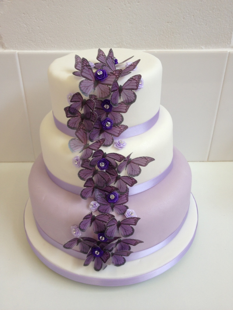 Three Tier Classic Round White and Lilac Wedding Cake with Cascading Butterflies